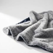 pet blanket draped over bolster dog bed